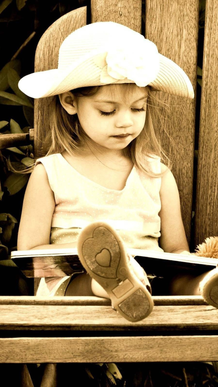 Little Girl Reading Book wallpaper 750x1334