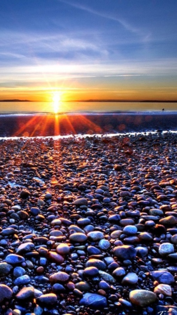 Обои Beach Pebbles In Sun Lights At Sunrise 360x640
