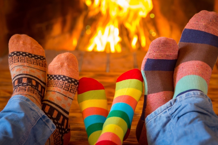 Happy family near fireplace wallpaper