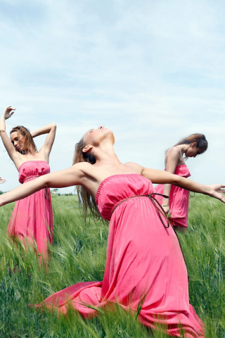 Fondo de pantalla Girl In Pink Dress Dancing In Green Fields 320x480