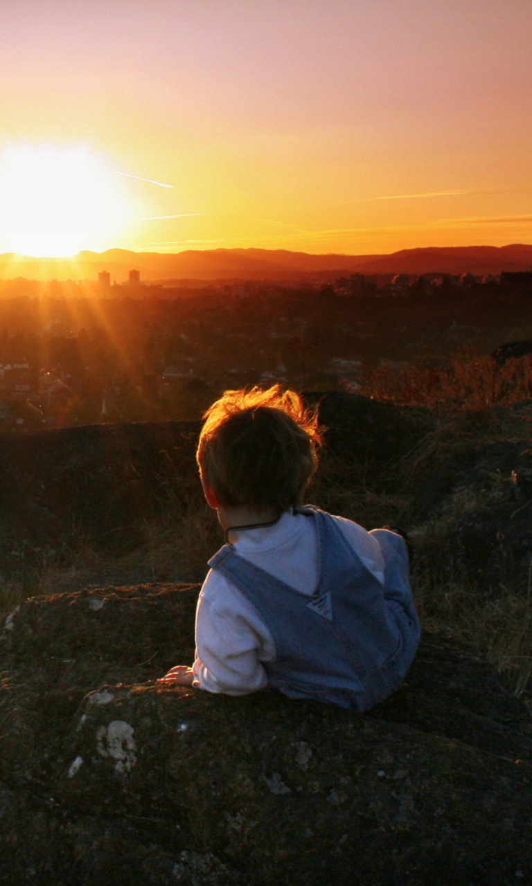 Little Boy Looking At Sunset From Hill wallpaper 768x1280