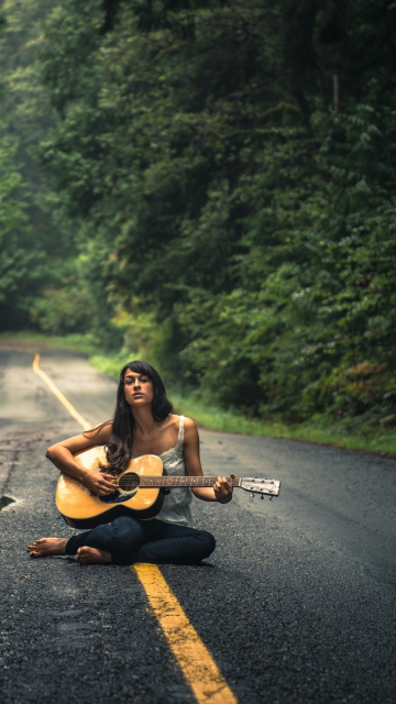 Das Girl Playing Guitar On Countryside Road Wallpaper 360x640