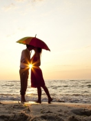 Das Couple Kissing Under Umbrella At Sunset On Beach Wallpaper 132x176