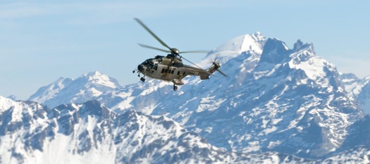 Обои Helicopter Over Snowy Mountains 720x320