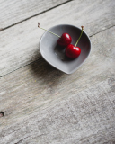 Das Two Red Cherries On Plate On Wooden Table Wallpaper 128x160