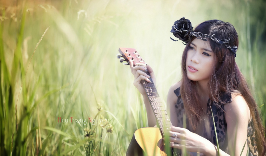 Pretty Girl In Grass Playing Guitar screenshot #1 1024x600