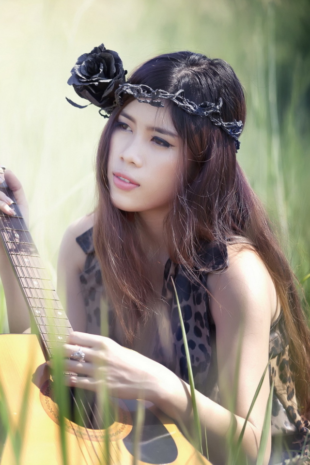 Sfondi Pretty Girl In Grass Playing Guitar 640x960
