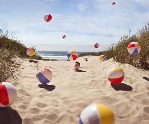 Beach Balls And Man's Head In Sand wallpaper 480x400