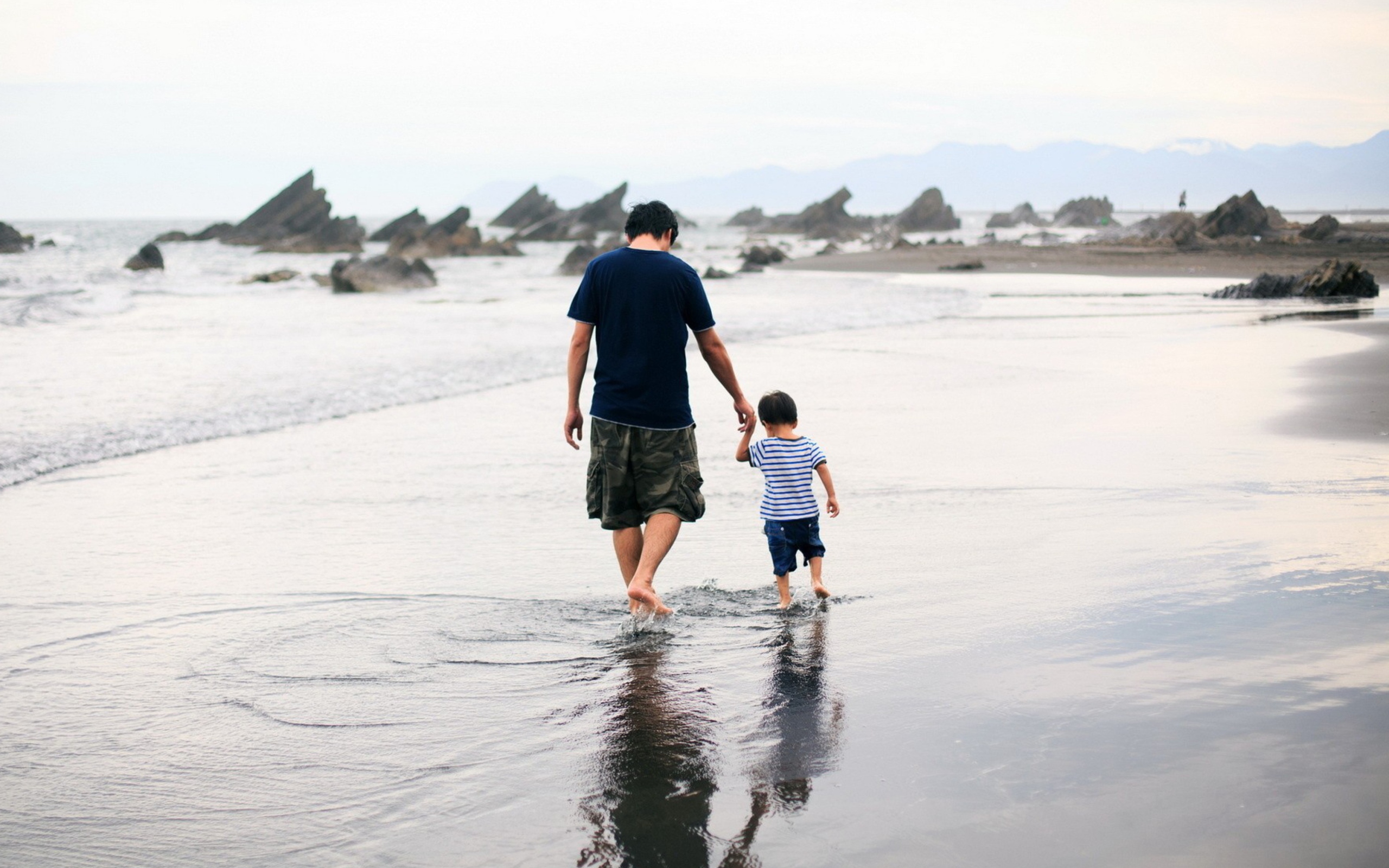 Father And Child Walking By Beach wallpaper 2560x1600