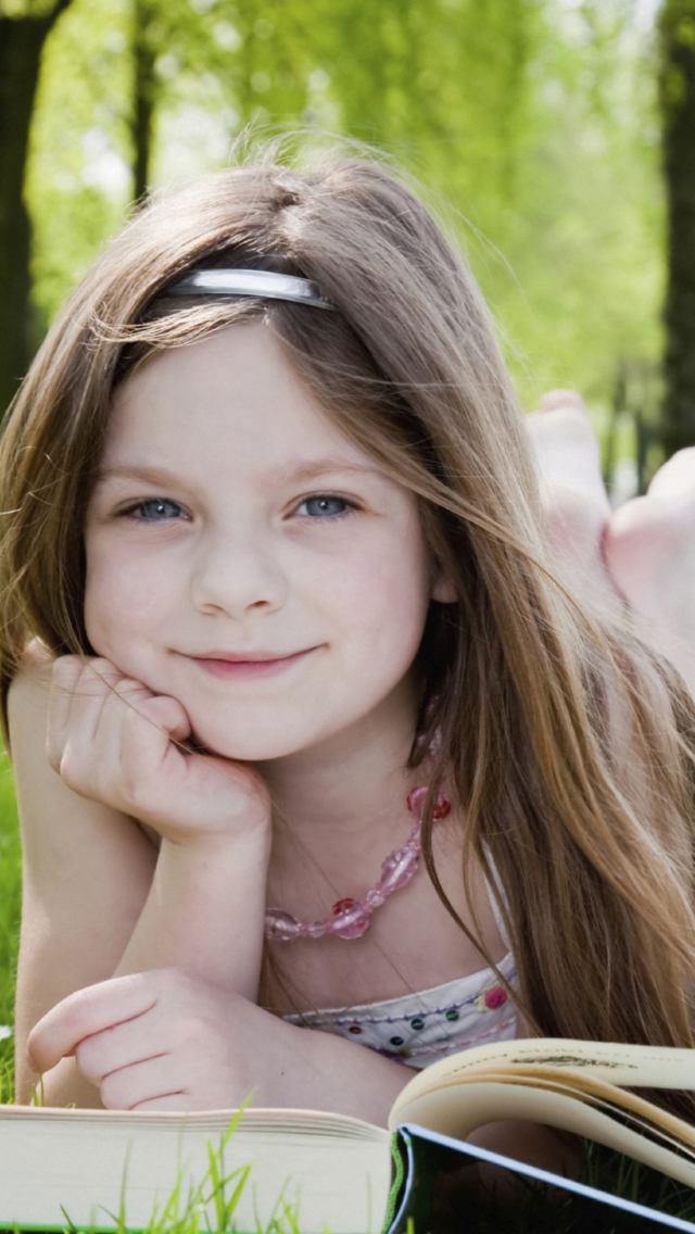 Cute Little Girl Reading Book In Garden wallpaper 640x1136