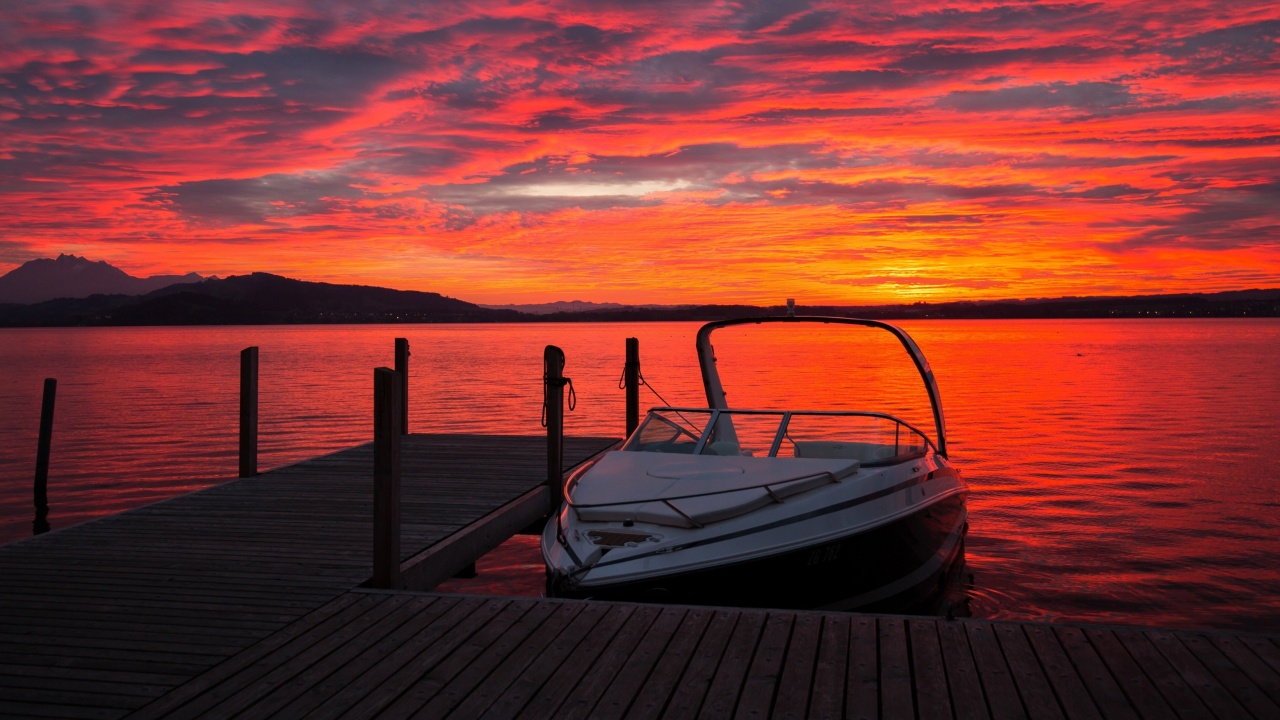 Sfondi Lake sunrise with boat 1280x720