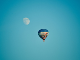 Обои Air Balloon In Blue Sky In Front Of White Moon 320x240