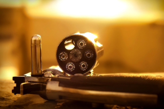 Revolver with Handgun Cartridges Background for Android, iPhone and iPad