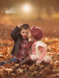 Boy and Girl in Autumn Garden wallpaper 240x320