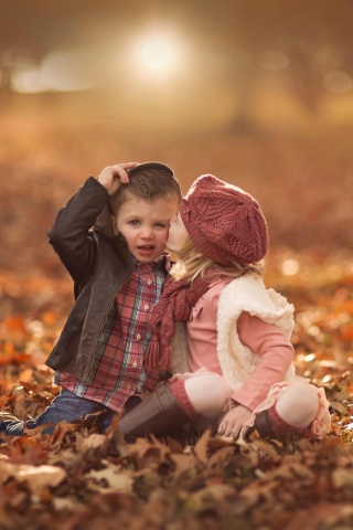 Boy and Girl in Autumn Garden wallpaper 320x480