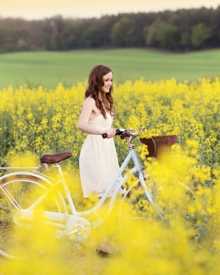 Girl With Bicycle In Yellow Field - Obrázkek zdarma pro Nokia C6-01