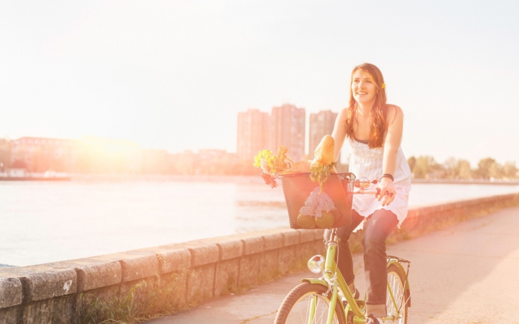 Girl On Bicycle In Sun Lights wallpaper