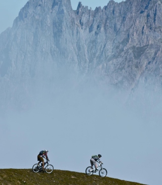 Обои Bicycle Riding In Alps Mountains на 1080x1920