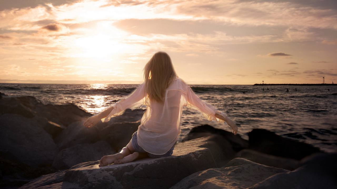 Girl Sitting On Stones On Sea Coast screenshot #1 1280x720