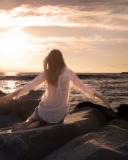 Screenshot №1 pro téma Girl Sitting On Stones On Sea Coast 128x160
