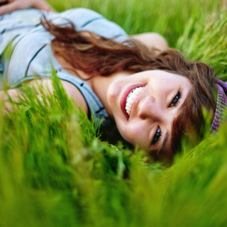 Smiling Girl Lying In Green Grass Background for 2048x2048