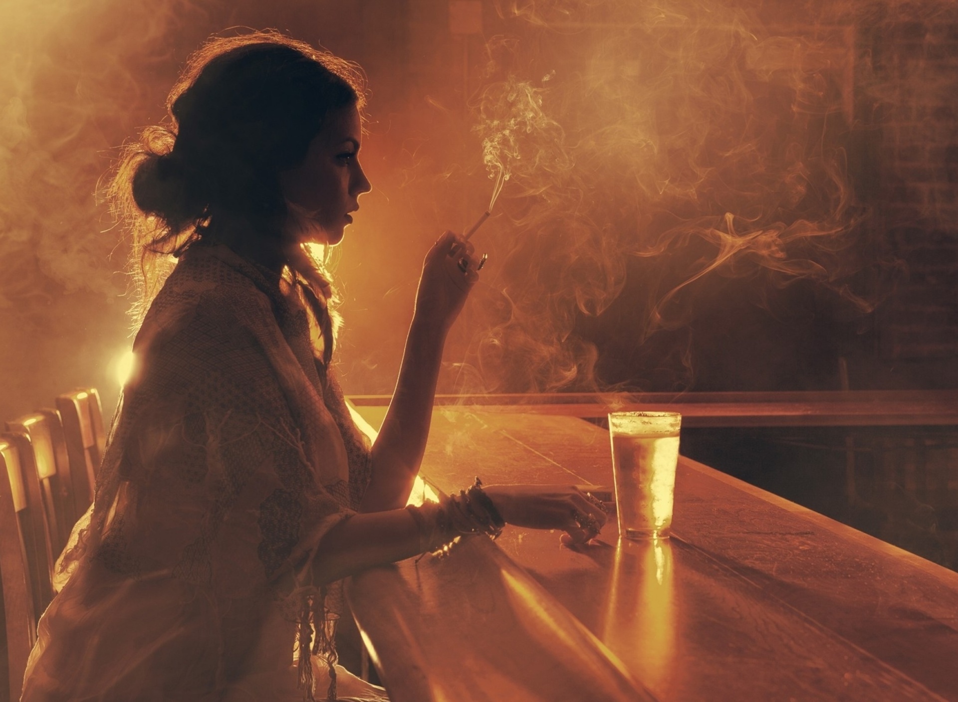 Sad girl with cigarette in bar wallpaper 1920x1408