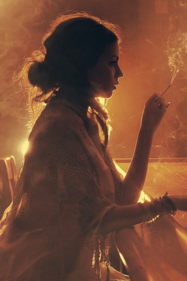 Sad girl with cigarette in bar wallpaper 640x960