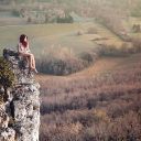 Обои Redhead Girl Sitting On Rock 128x128