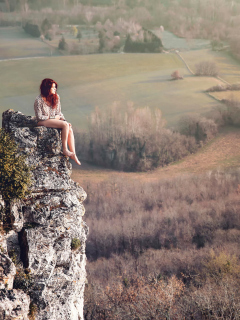 Обои Redhead Girl Sitting On Rock 240x320