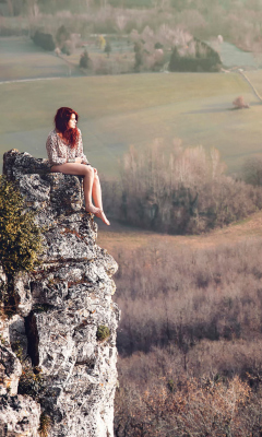 Redhead Girl Sitting On Rock wallpaper 240x400