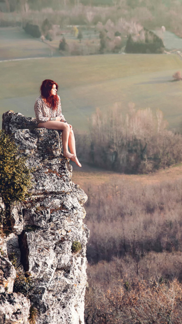 Обои Redhead Girl Sitting On Rock 360x640