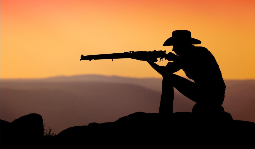Das Cowboy Shooting In The Sunset Wallpaper 1024x600