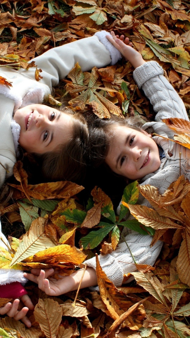 Cute Child Girls On Autumn Leaves Carpet wallpaper 640x1136