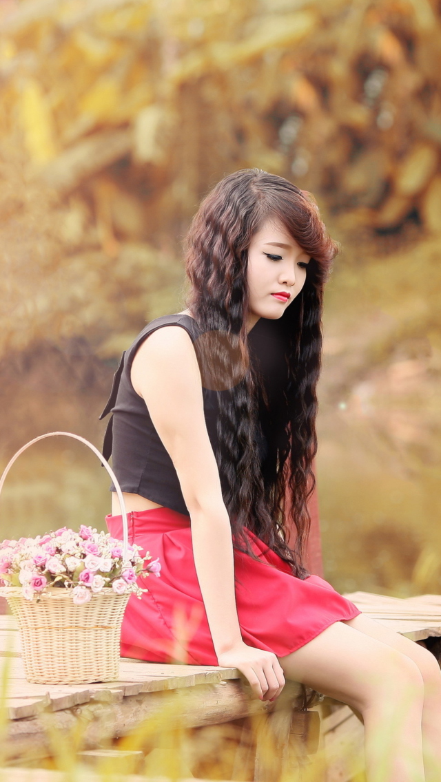 Sad Asian Girl With Flower Basket wallpaper 640x1136