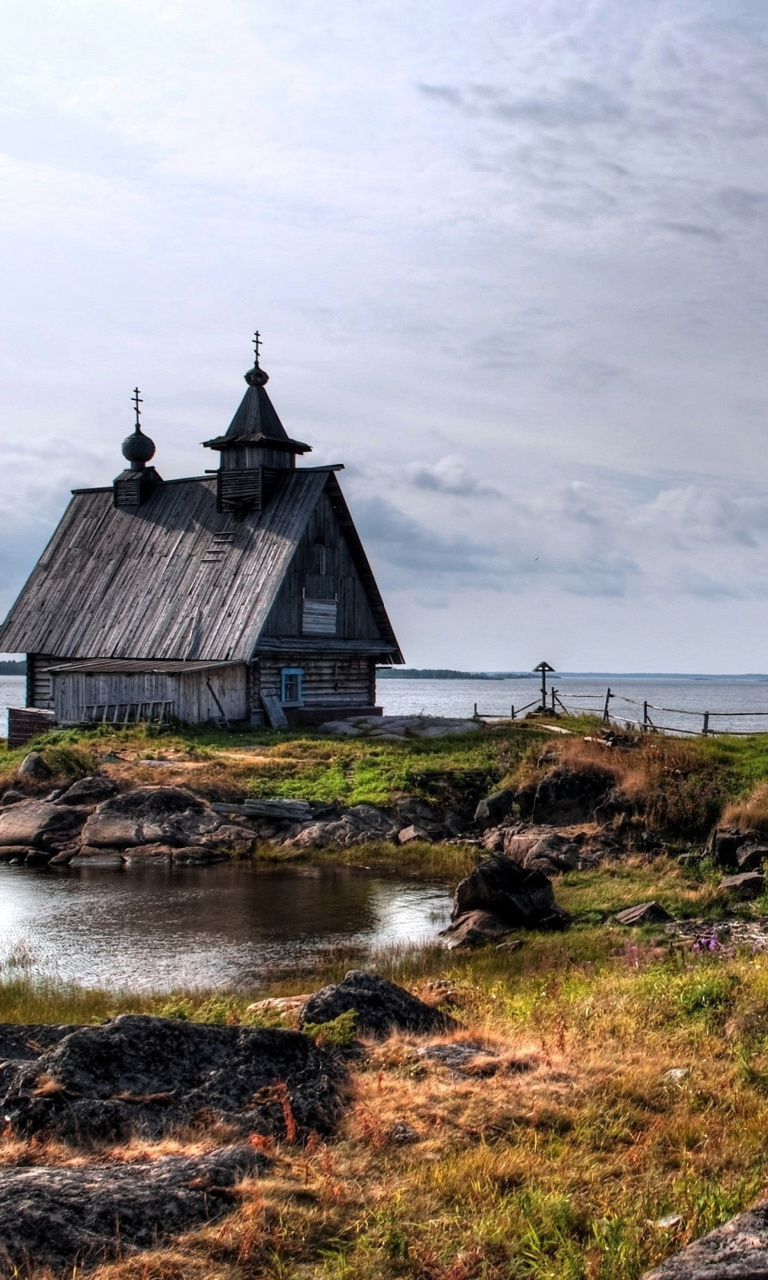 Обои Old small house on the rocky river shore 768x1280