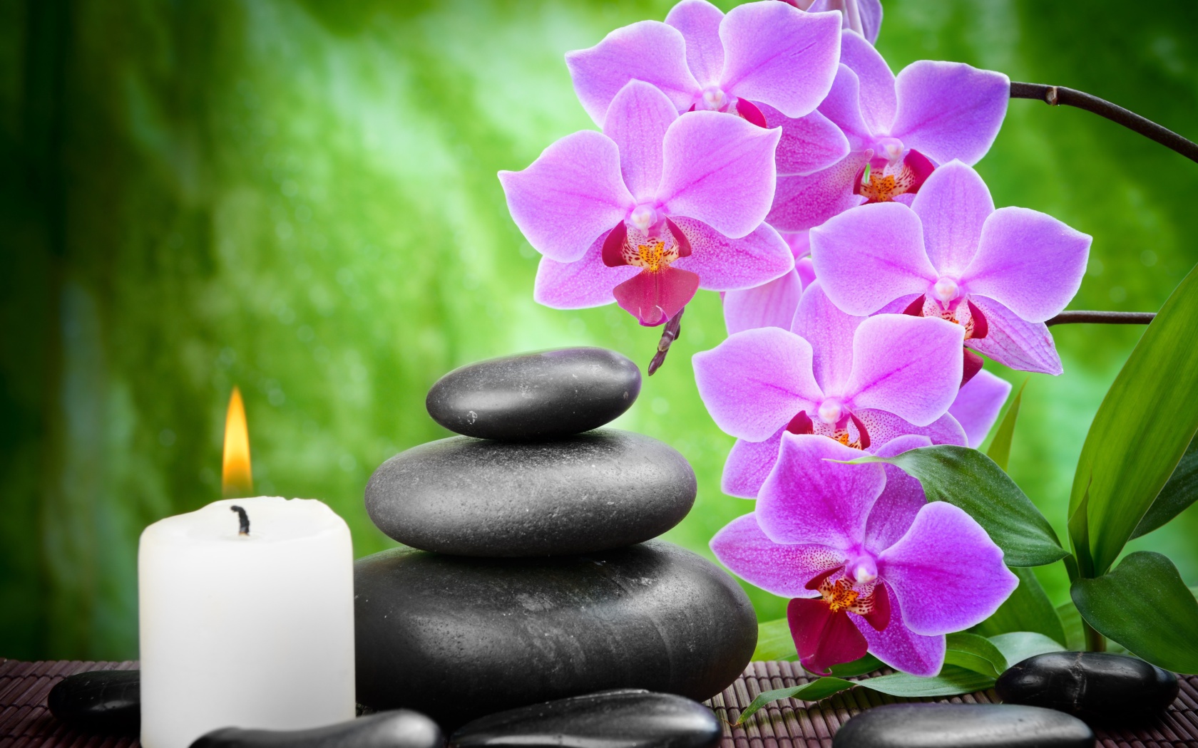 Pebbles, candles and orchids wallpaper 1680x1050