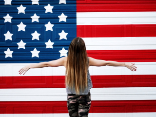 American Girl In Front Of USA Flag wallpaper 320x240