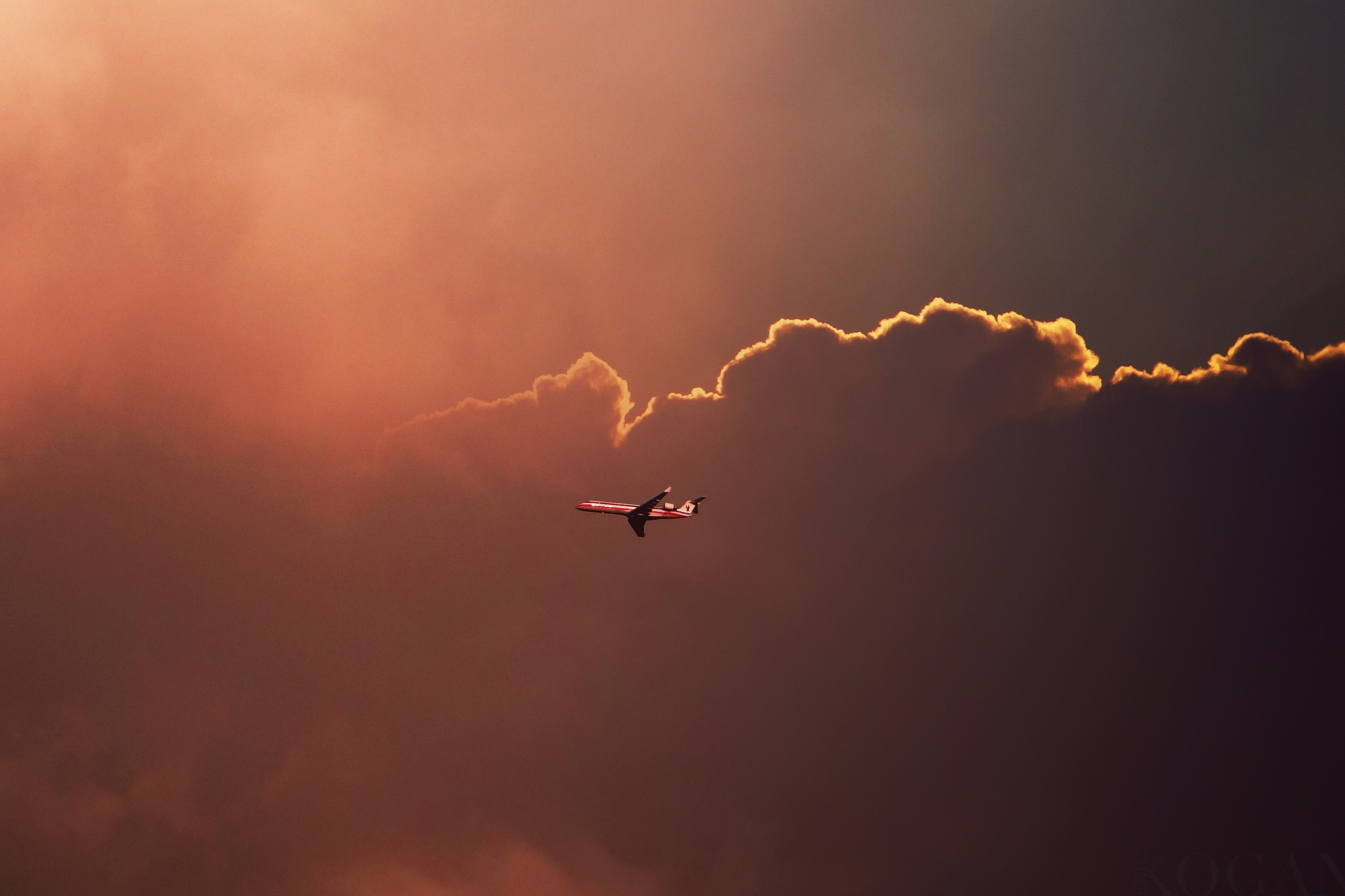 Das Airplane In Red Sky Above Clouds Wallpaper 2880x1920