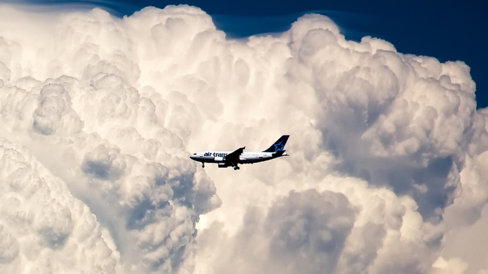 Plane In The Clouds wallpaper 1600x900