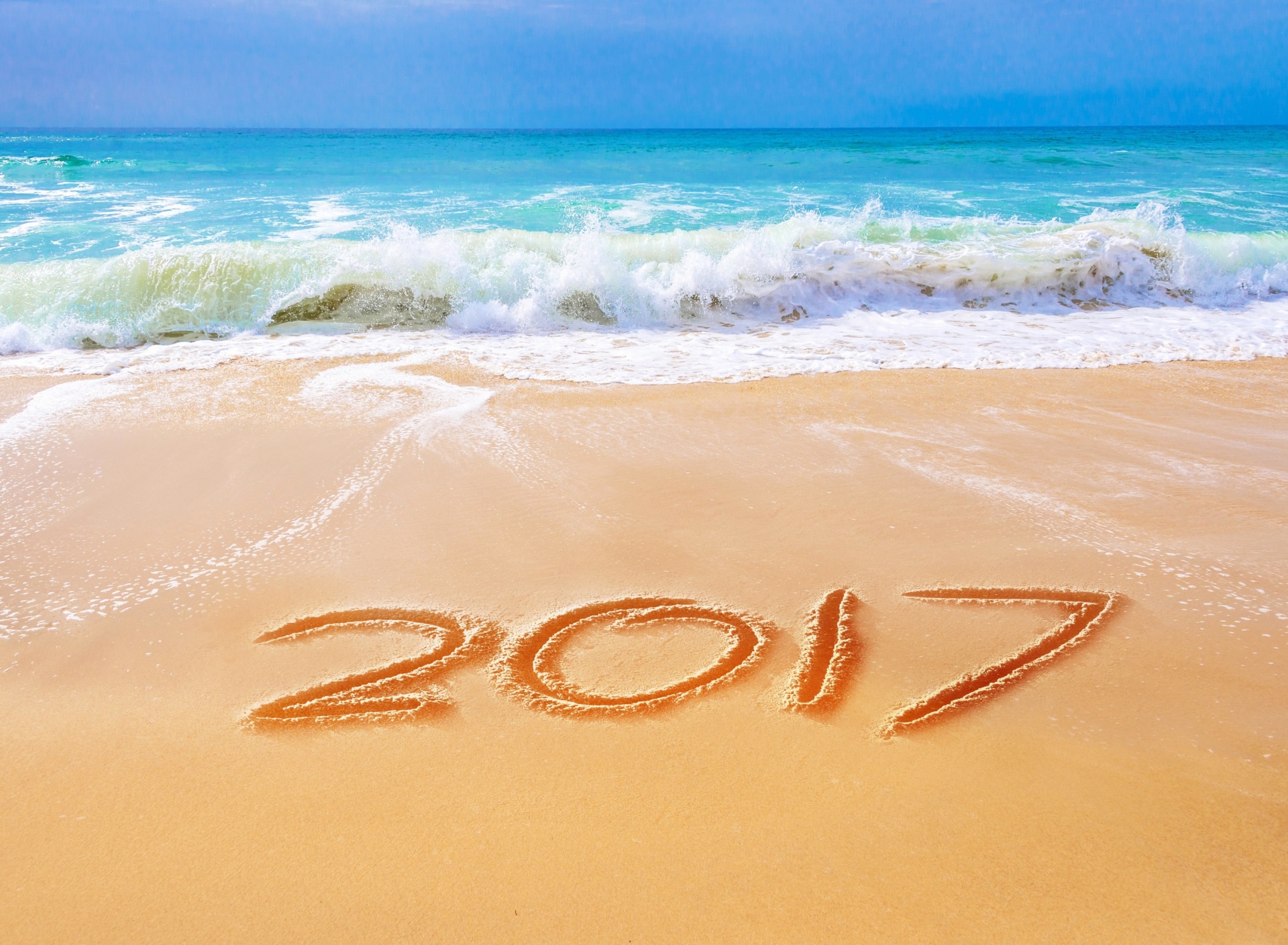 Обои Happy New Year 2017 Phrase on Beach 1920x1408