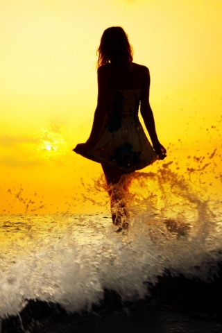 Girl Silhouette In Sea Waves At Sunset wallpaper 320x480