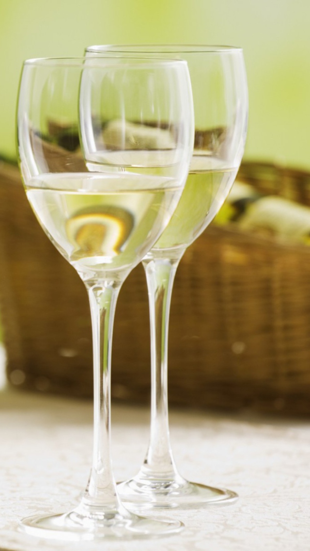 Two Glaeese Of White Wine On Table wallpaper 640x1136