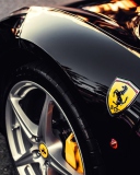 Обои Black Ferrari With Yellow Emblem 128x160