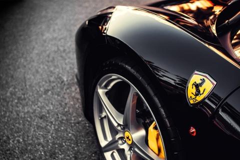 Обои Black Ferrari With Yellow Emblem 480x320