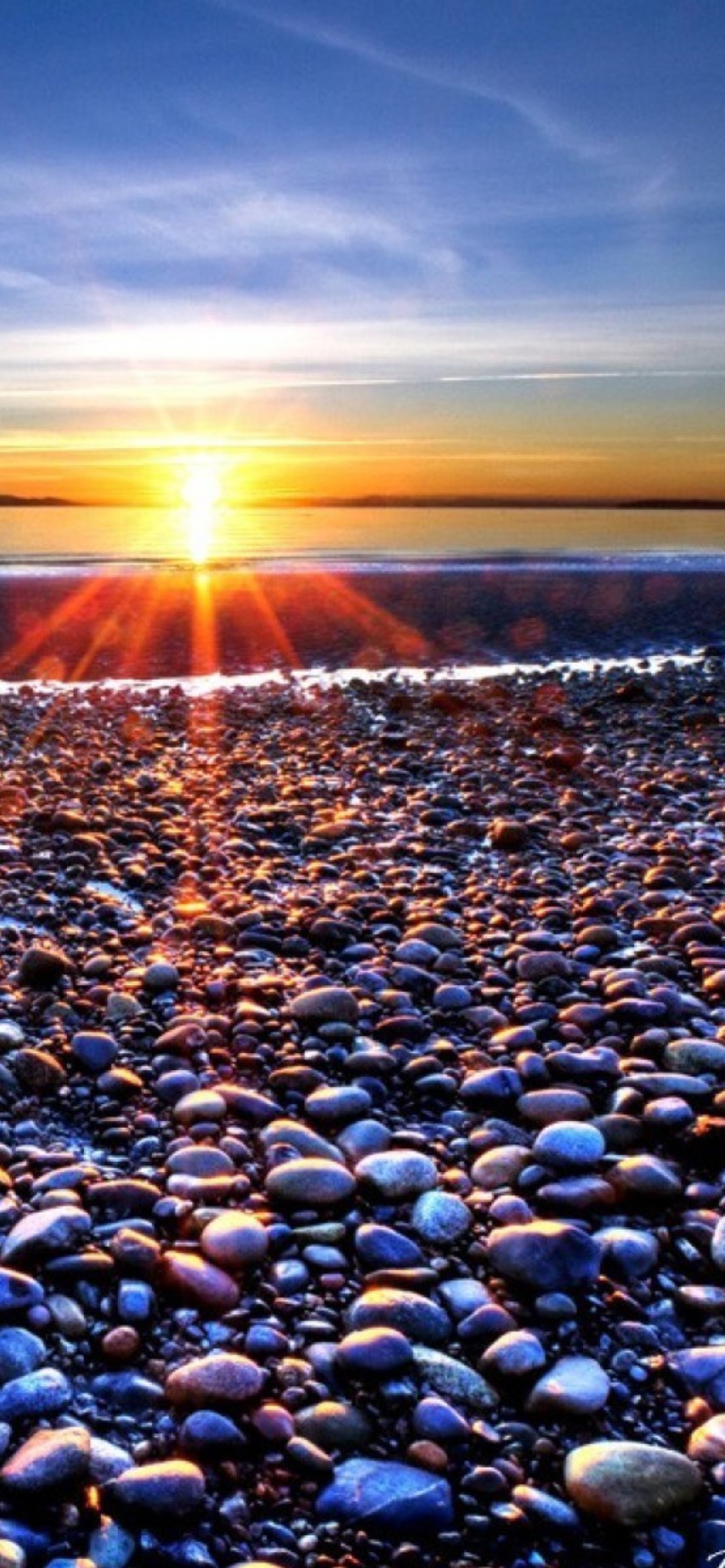 Beach Pebbles In Sun Lights At Sunrise wallpaper 1170x2532