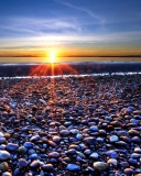 Das Beach Pebbles In Sun Lights At Sunrise Wallpaper 128x160