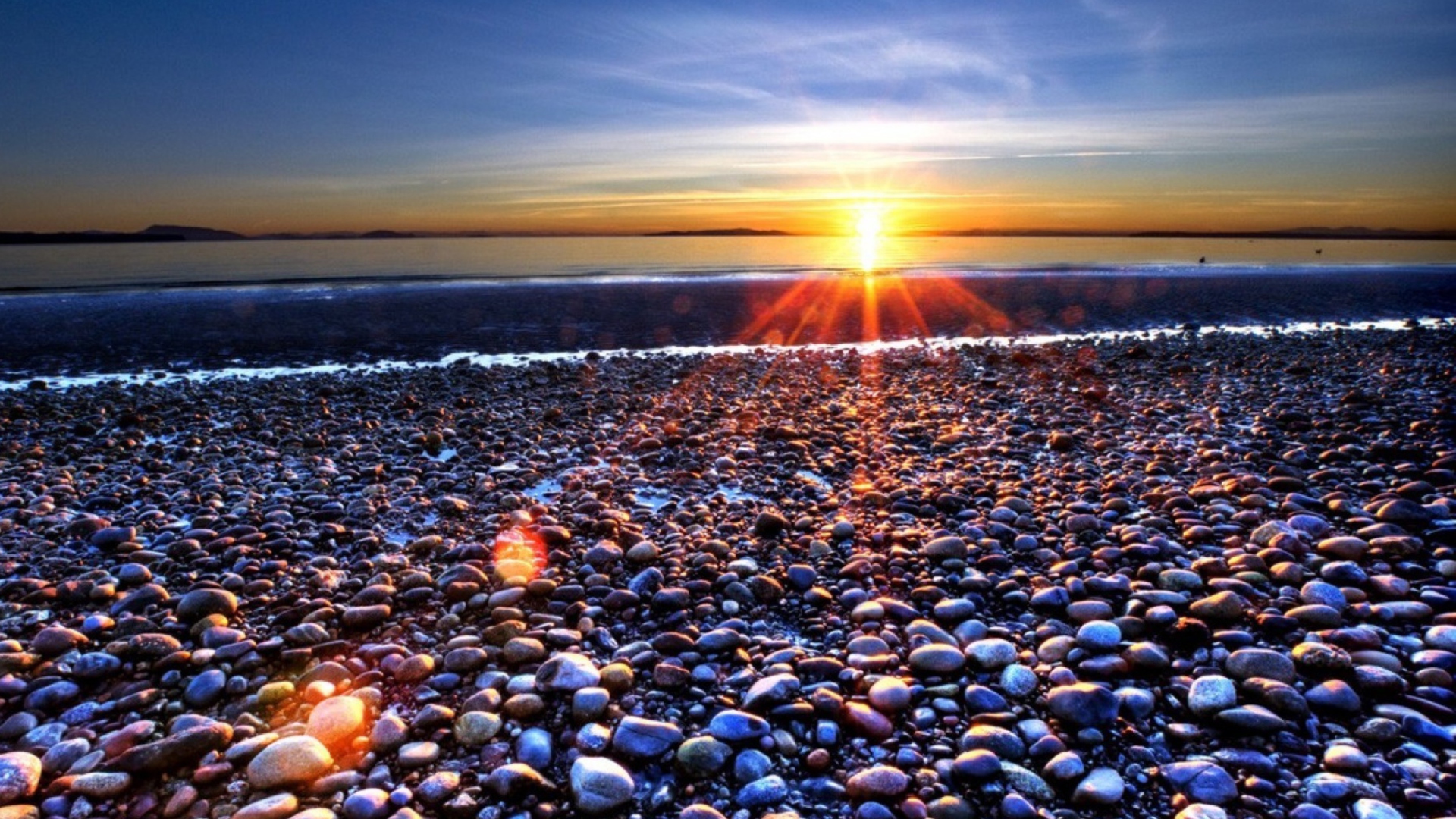 Beach Pebbles In Sun Lights At Sunrise wallpaper 1920x1080