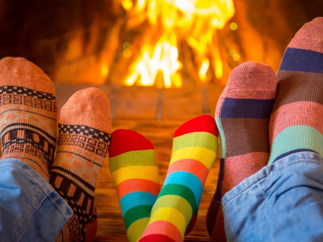 Happy family near fireplace wallpaper 640x480