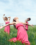 Sfondi Girl In Pink Dress Dancing In Green Fields 128x160