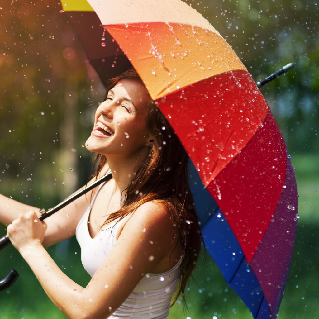 Fondo de pantalla Happy Girl With Rainbow Umbrella Under Summer Rain 1024x1024